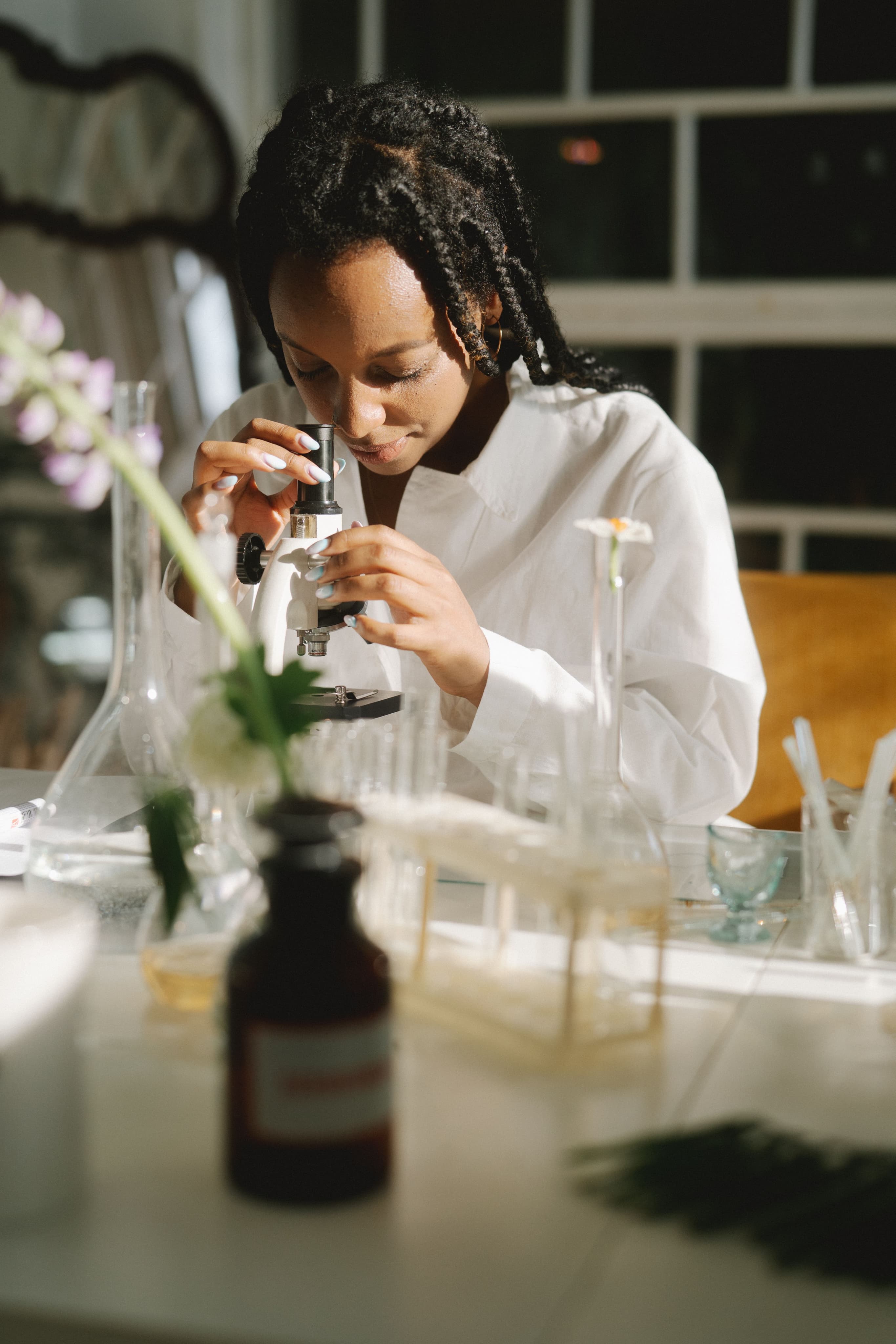 Scientist examining samples under a microscope in a laboratory